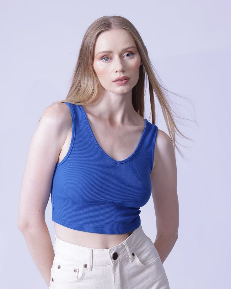 Flaunt your curves in this sultry and slim-fitting V-neck crop top! Crafted from a high stretch rib-knit fabric with a blend of 97% polyester and 3% spandex, this casual and comfortable piece is ideal for any occasion. Machine wash or professionally dry-clean for effortless care. Seamless V-neck Top For Summer, Chic Fitted V-neck Crop Top, Trendy Seamless V-neck Crop Top, Fitted Ribbed V-neck Tank Top, Blue Ribbed V-neck Tank Top, Trendy Solid V-neck Crop Top, Trendy V-neck Bra Friendly Tops, Ribbed Fitted Crop Top, Ribbed V-neck Elastane Top