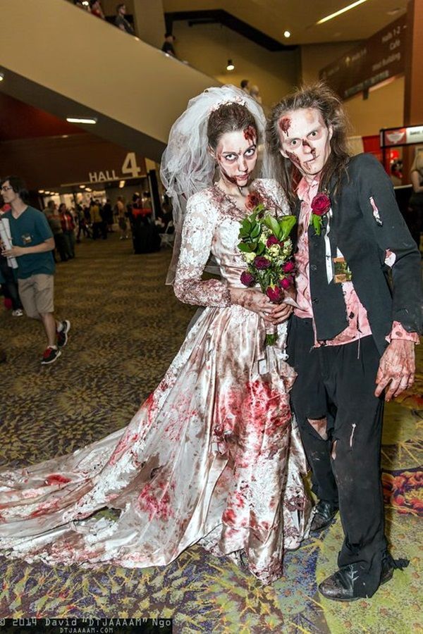 two people dressed up as zombies and brides in an airport lobby for a halloween wedding