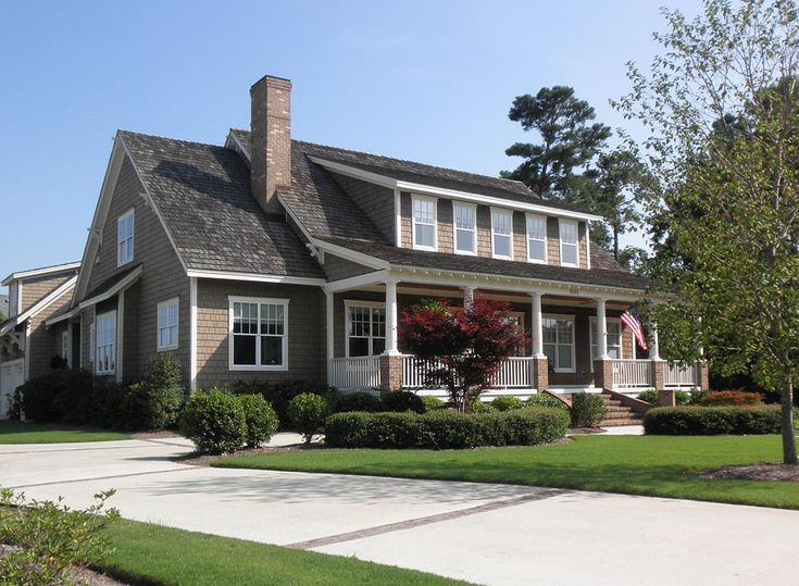 a large house with lots of windows in the front yard