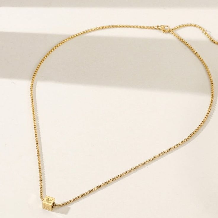 Durable and stylish, our waterproof necklace is crafted for both functionality and fashion. Perfect for any occasion, it's the ideal accessory for those who appreciate durability and timeless elegance. Perfect for the minimalist and a beautiful piece to layer with. A true versatile statement piece that you can wear straight from the pool to dinner! - 18K gold plated / stainless steel - Waterproof technology - 18" in length - Necklace + 1 cube (initial or sign) = $45 - Additional cubes with lette Adjustable Minimalist Chain Necklace Choker, Minimalist Choker Jewelry With Adjustable Length, Minimalist Adjustable Choker Jewelry, Everyday Jewelry With Delicate Square Pendant Chain, Minimalist Adjustable Choker Necklace, Minimalist Charm Necklace With Adjustable Chain, Everyday Square Pendant Clavicle Chain Jewelry, Minimalist Jewelry With Delicate Chain And Square Pendant, Everyday Square Pendant Clavicle Chain