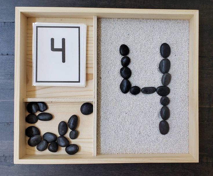 a wooden box filled with rocks and letters