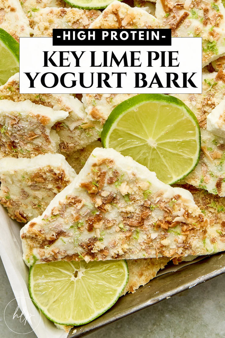 key lime pie yogurt bark on a baking sheet with limes and graham crackers