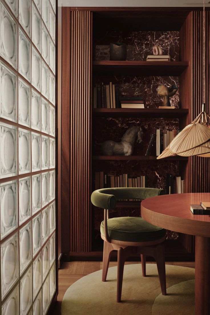 a wooden table sitting next to a book shelf filled with books