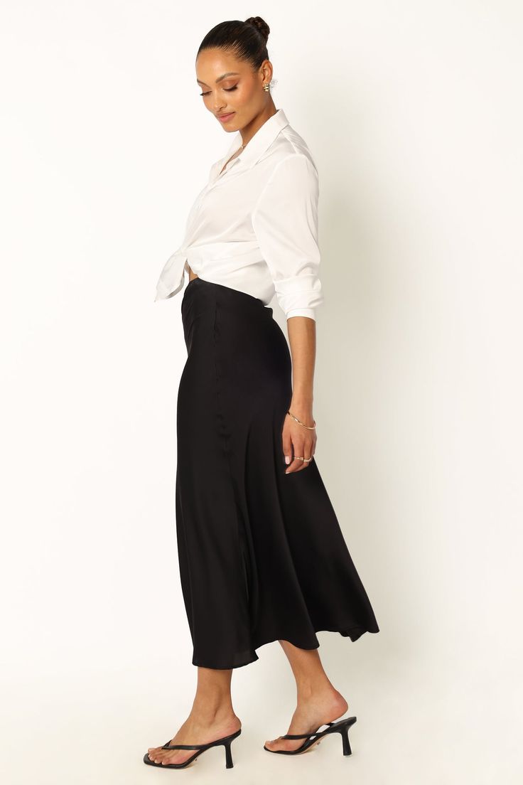 DETAILS
This midi skirt will be your go-to for everyday style. Crafted from a soft satin fabric, it features an elasticised waistband and a pull on design for fuss-free dressing. The black color is a timeless classic that you'll reach for again and again.

midi length
elasticised waist
pull on design
soft satin feel
unlined
material - 97% polyester / 3% spandex









SIZING

model 1 is 5' 7" and wears a Size XS

model 1 stats: bust - 32", waist - 25", hips - 37"
model 2 is 5' 1" and wears a S Satin Dresses Long, Satin Dresses Long Sleeve, Petal And Pup, Black Tie Wedding Guests, White Dress Shoes, Essential Dress, Resort Dresses, Satin Midi Skirt, Crop Top Tees