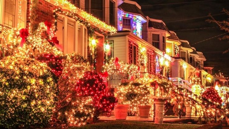 christmas lights decorate homes and trees in the neighborhood