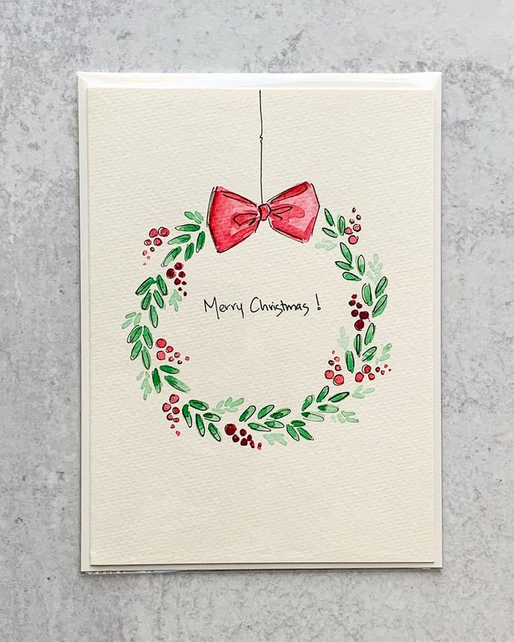 a christmas card with a red bow hanging from it's side and the words merry christmas written on it