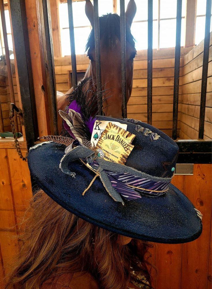 This striking blue hat is designed to make a bold fashion statement and is perfect for those who seek to stand out from the crowd. Crafted with passion and attention to detail, this rancher hat features a unique burned effect that adds a distinct character to its appearance. The captivating blue hue, reminiscent of a clear summer sky, is sure to catch everyone's eye. Whether you're attending a music festival, a casual outing, or simply want to elevate your everyday style, this hat is an excellent choice. Adorned with feathers and a delicate chain, this hat exudes a bohemian vibe that effortlessly complements any outfit. The feathers add a touch of elegance, while the chain adds a subtle edginess, creating a perfect balance between femininity and daring fashion. Please NOTE: This hat is a c Bohemian Costume Hats With Curved Brim For Rodeo, Bohemian Flat Brim Costume Hats For Rodeo, Bohemian Costume Hat With Flat Brim For Festivals, Handmade Short Brim Costume Hats For Festivals, Handmade Festival Costume Hats With Short Brim, Bohemian Brimmed Costume Hats For Festivals, Bohemian Flat Brim Costume Hat For Festivals, Handmade Bohemian Costume Hat With Curved Brim, Handmade Bohemian Hat With Curved Brim