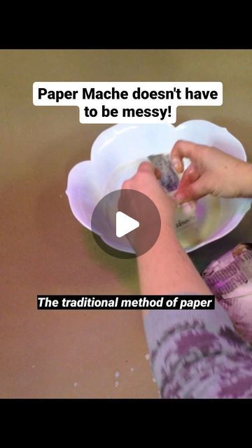 a person is using a paper mache to make a bowl with food in it