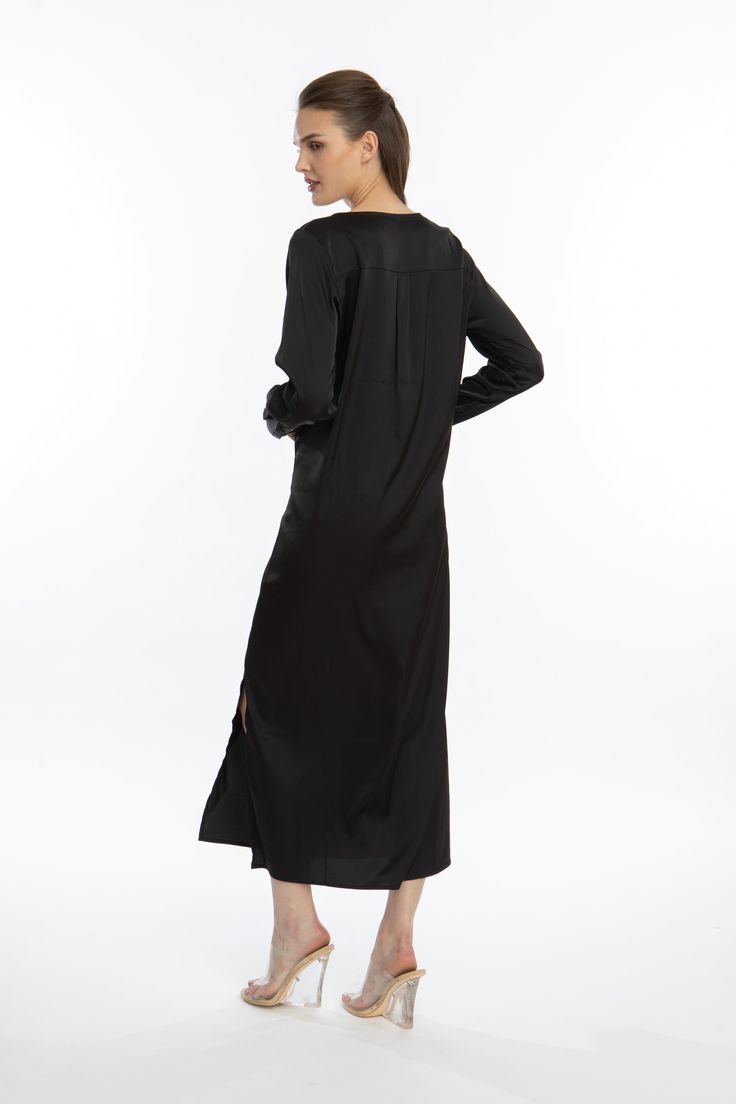 Step out and be seen in this stylish Noir Long Sleeve Tunic Dress. Soft, velvety poly silk and lightweight design will keep you looking cool and chic, whether you're lounging at home or giving your style a night-time pick-me-up. Get ready to feel luxuriously comfy all day and night! Long Sleeve Tunic Dress Elegant, loose fit Notched neckline Long sleeve with button placket Bottom side slits on both sides Lusciously soft poly-silk blend for ease of care Machine wash cool Tumble-dry low Long Sleeve Tunic Dress, Notched Neckline, Dress Elegant, Long Sleeve Tunic, Day And Night, Button Placket, Night Time, Tunic Dress, Elegant Dresses