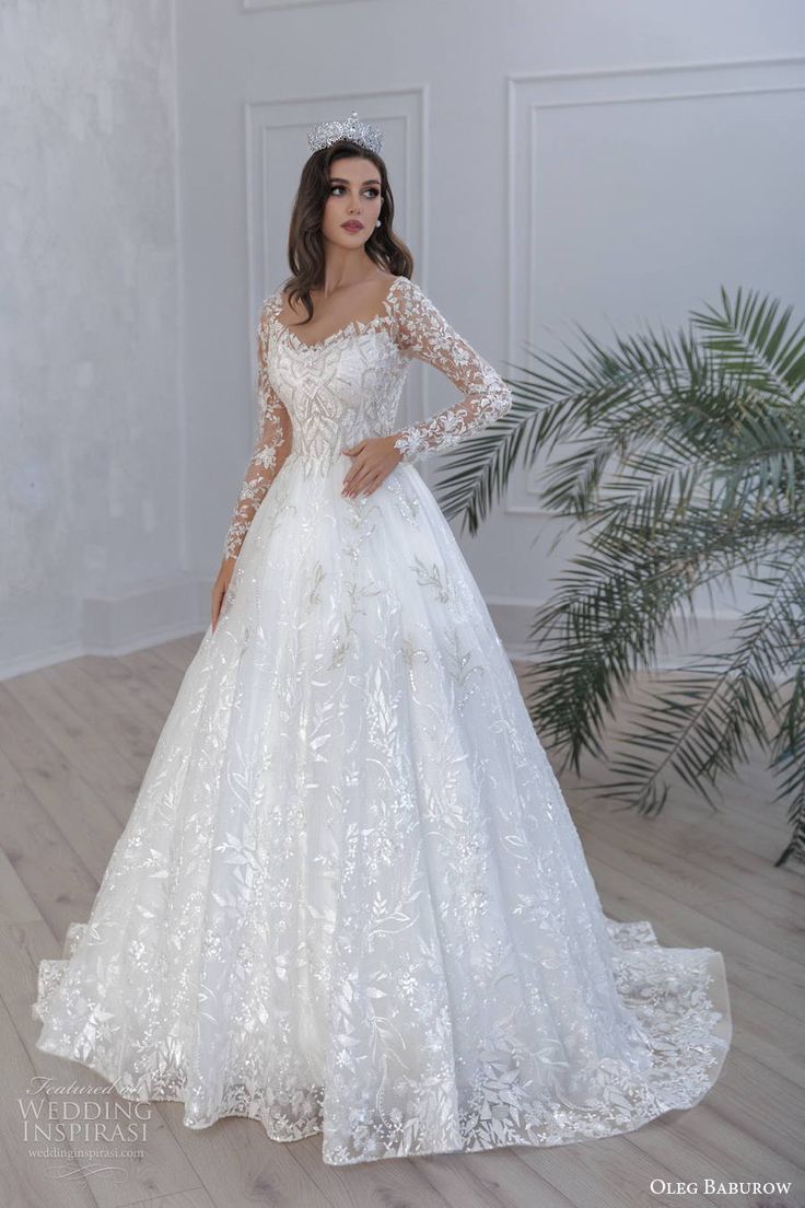 a woman in a white wedding dress standing on a wooden floor wearing a tiara