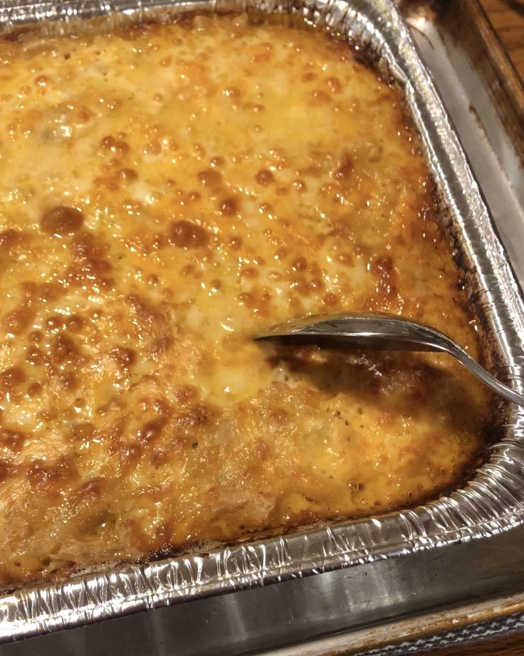 a casserole in a pan with a spoon sticking out of the top, ready to be eaten