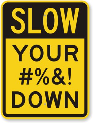 a yellow and black sign with the words slow your 0 % & down on it