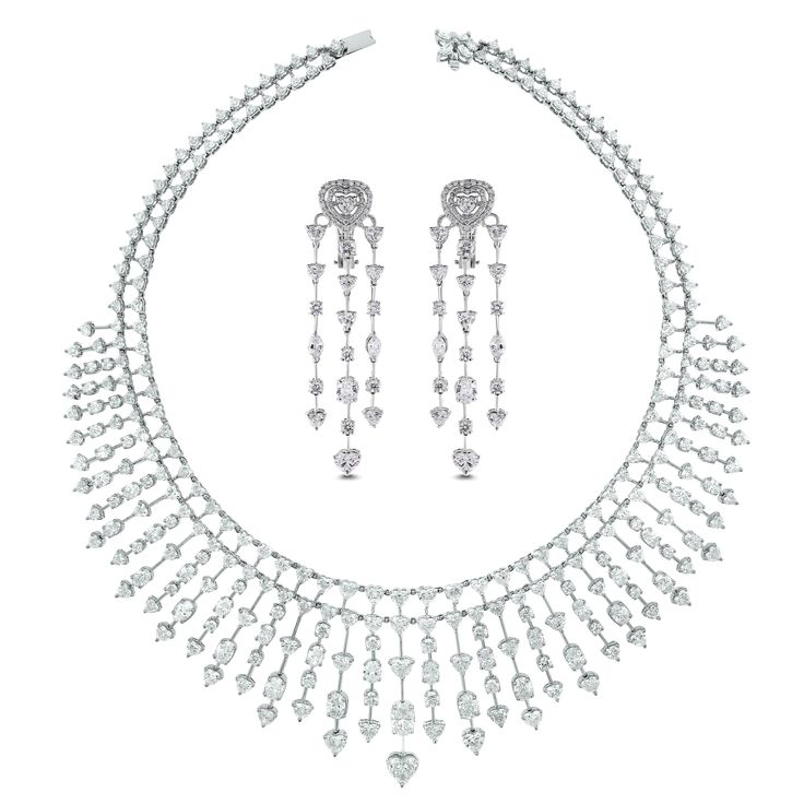 An enchanting necklace & earring suite is ideal for the red carpet, a gala or a royal wedding. The luxurious combination of hearts, ovals and rounds is breathtaking and show stopping. Diamonds Shapes: Heart, Round, Marquise & OvalCenter Solitaire: 1.08 ct Heart Shape GH color SI ClarityTotal Diamond Weight: 51.25 ct (Necklace) & 7.19 ct (Earrings) Diamond Color: G - I Diamond Clarity: VS (Very Slightly Included) Metal: 18K White Gold Metal Wt: 83.17 gms (Necklace) & 20.34 gms (Earrings) Setting: White Gold Heart Necklace, Bridal Diamond Necklace, Necklaces Choker, Vintage Choker Necklace, Diamond Cluster Earrings, Gold For Sale, Fancy Necklace, Vintage Choker, Hearts Necklace