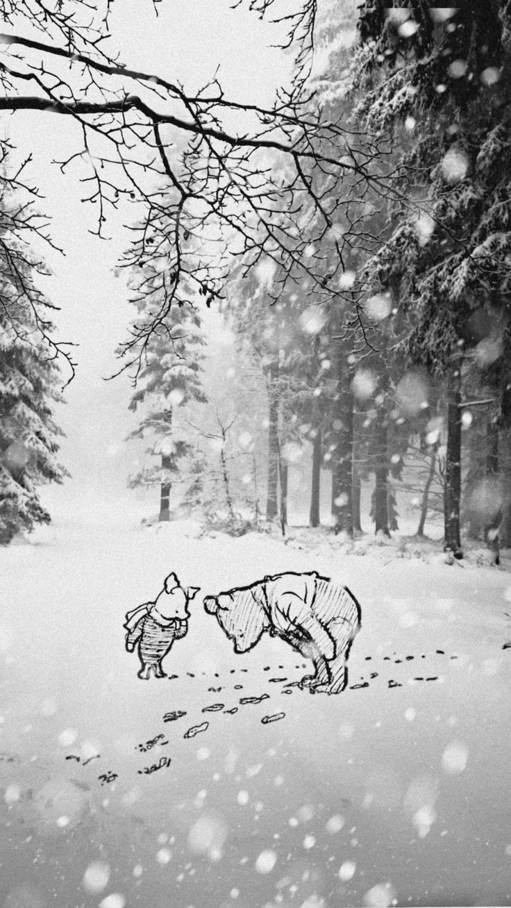 a black and white photo of a bear in the snow