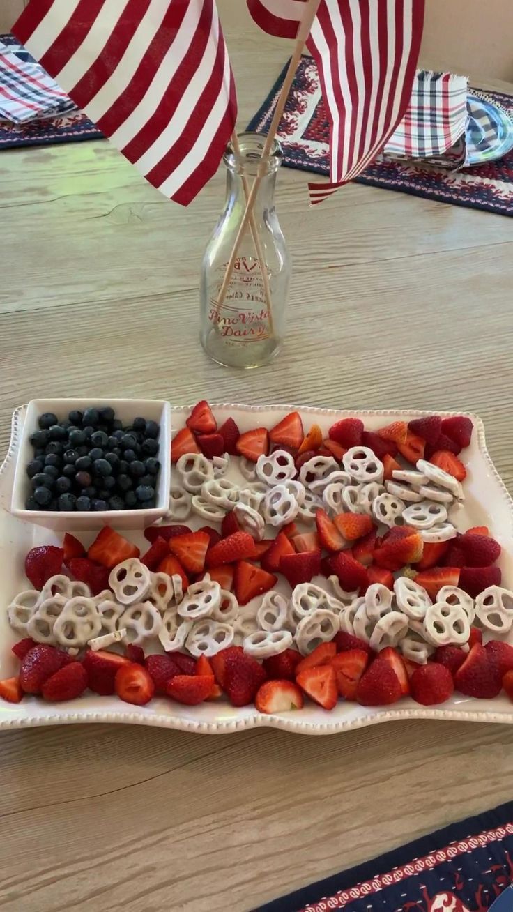 an american flag tray with strawberries, blueberries, and berries on the side