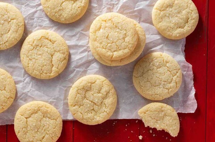 a bunch of cookies sitting on top of a piece of wax paper next to each other