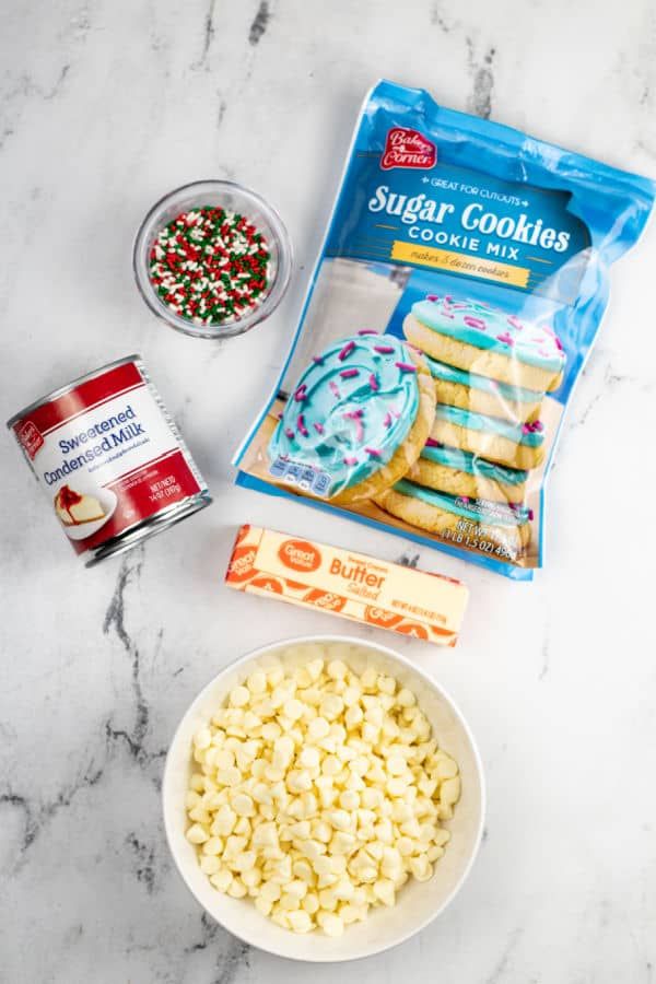 ingredients to make sugar cookies laid out on a marble counter