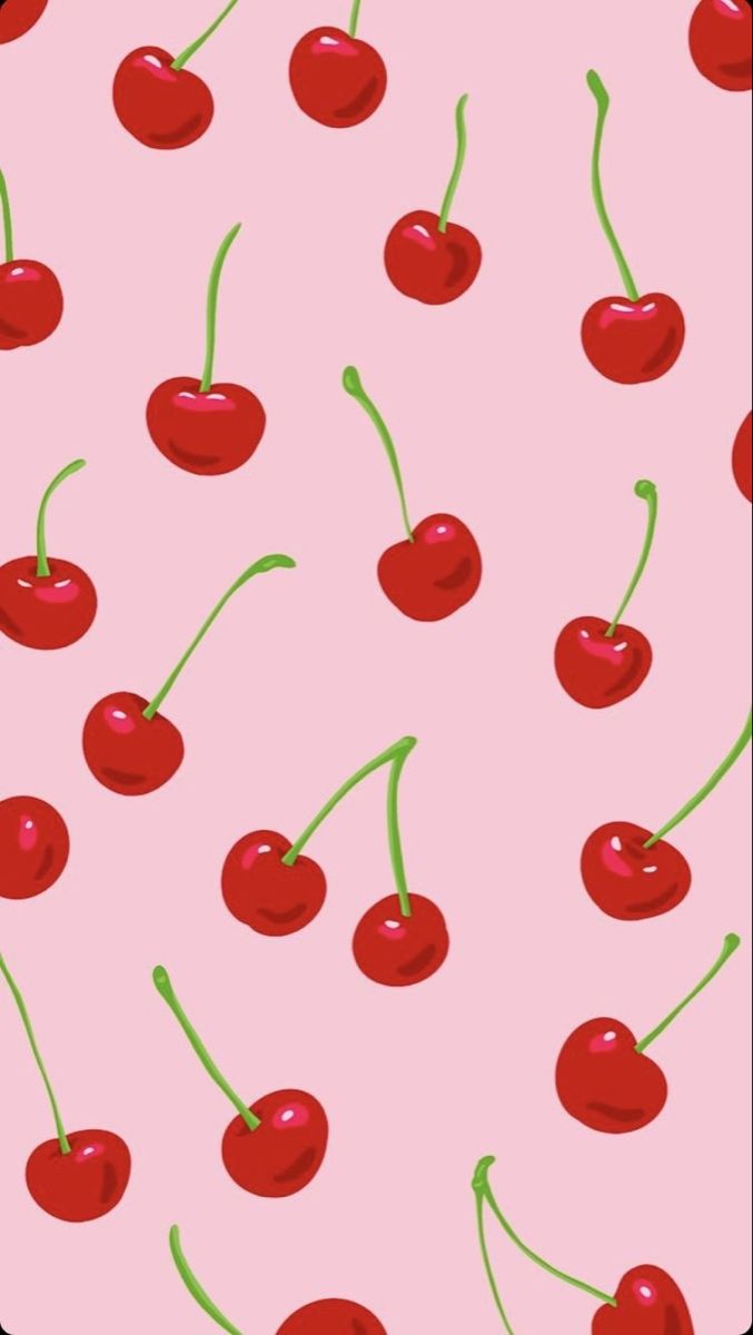 a pink background with cherries and green stems