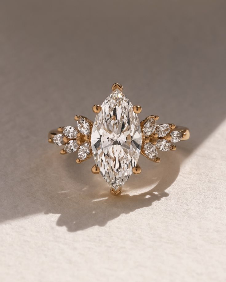 an oval cut diamond ring with pear shaped diamonds