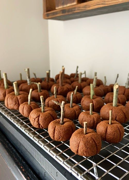 small pumpkins are sitting on a cooling rack in the kitchen, ready to be eaten