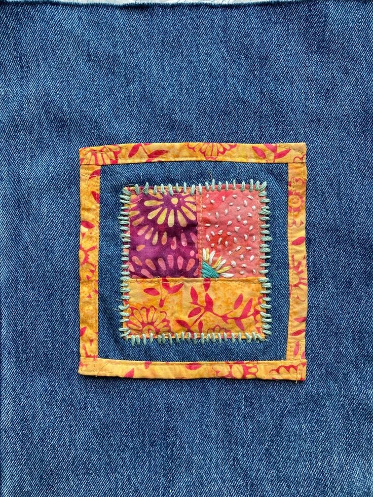 a piece of fabric with colorful designs on it and some blue material in the middle