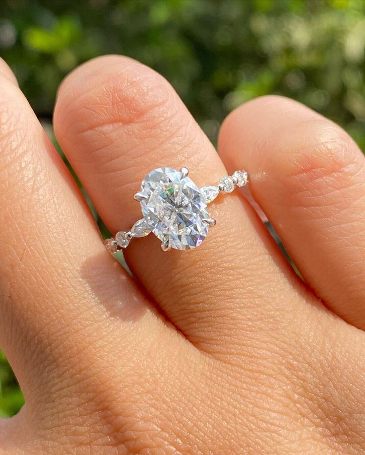 a woman's hand with a diamond ring on it