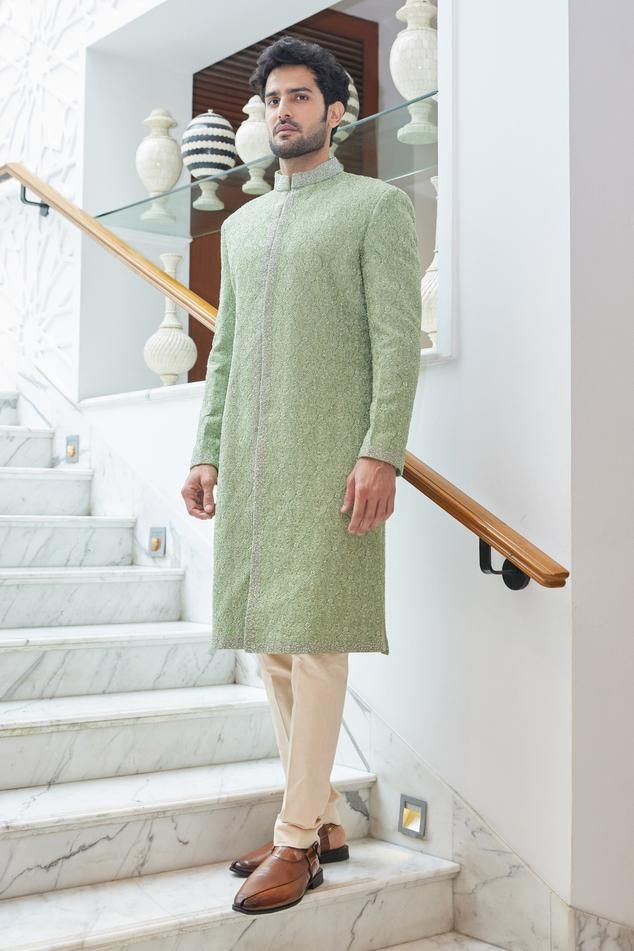 Mint green raw silk sherwani embroiderd in tonal resham highlighted by tonal and light gold beadwork and crystals. Paired with a kurta and churidar.
Components: 3
Pattern: Embroidered
Type Of Work: Resham
Neckline: Band collar
Sleeve Type: Long
Fabric: Raw Silk, Monga Tussar, Cotton Lycra
Color: Green
Occasion: Mehendi and Puja - Aza Fashions Unstitched Pista Green Sherwani With Resham Embroidery, Pista Green Embroidered Long Sleeve Sherwani, Semi-stitched Pista Green Sherwani With Resham Embroidery, Semi-stitched Embroidered Pista Green Sherwani, Green Semi-stitched Long Sleeve Sherwani, Band Collar, Custom Tailoring, Churidar, Embroidered Silk