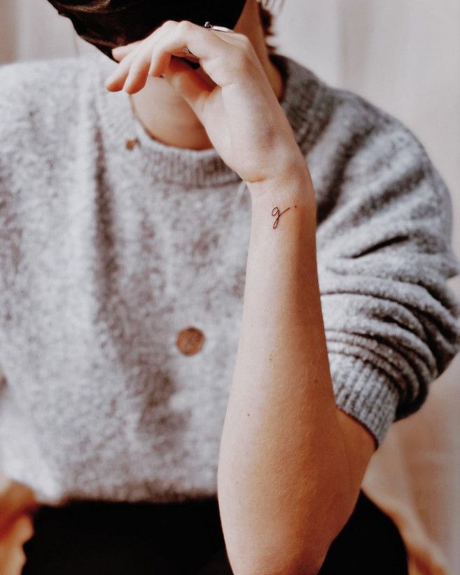 a woman with a small tattoo on her arm