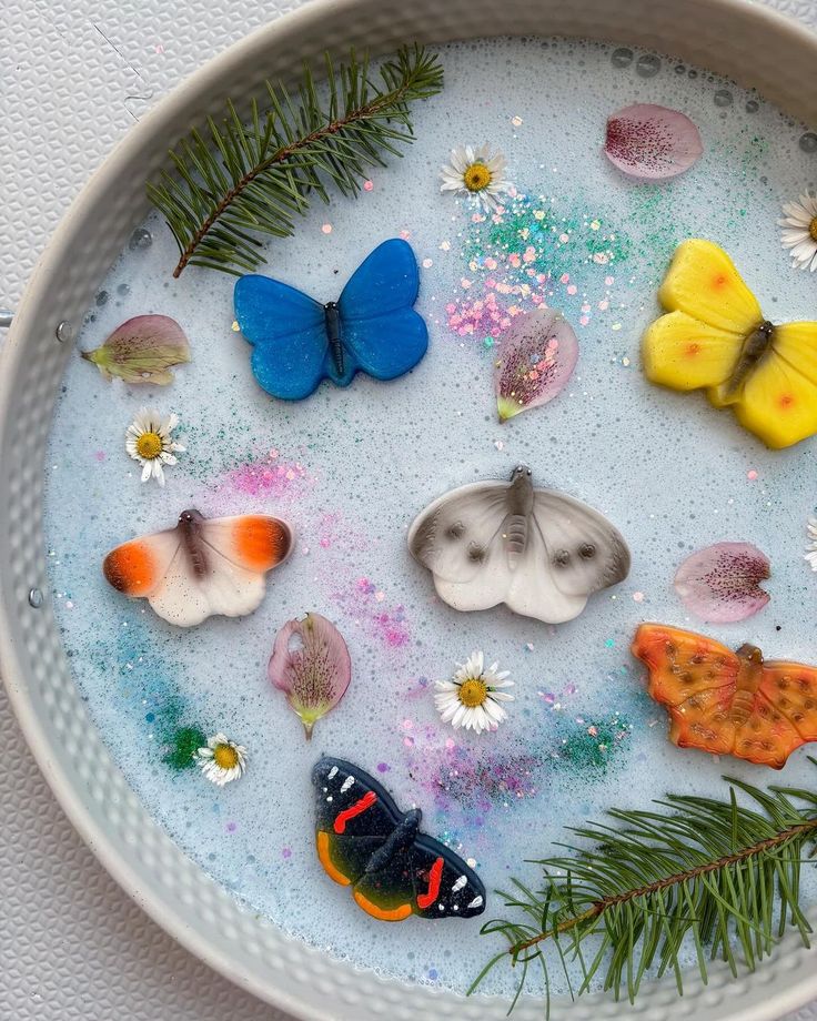 a bowl filled with lots of different types of butterflies