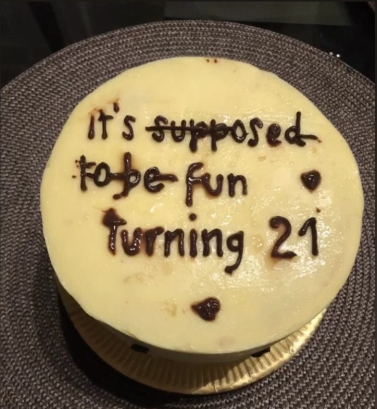 a cake with writing on it that says it's supposed to be fun turning 21