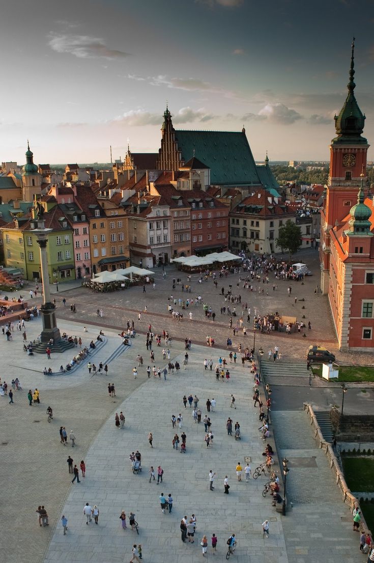 an aerial view of people walking around in a city square at sunset or sunrise time