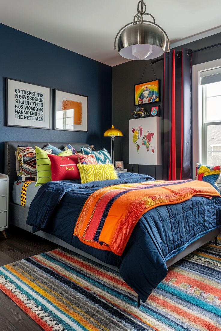 a bedroom with blue walls, colorful bedding and pictures on the wall above it