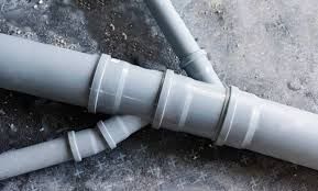 two gray pipes laying on the ground next to each other