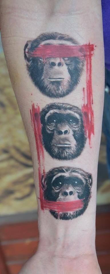 a tattoo with three different monkeys on the arm and one is wearing a red headband