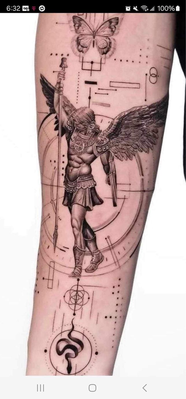 a man with an angel tattoo on his arm and leg, next to a clock