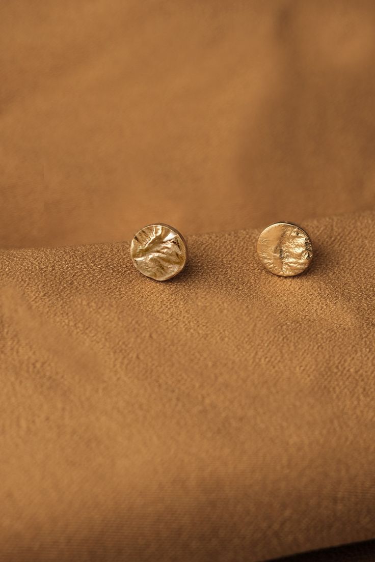 "Hammered stud earrings gold, Small Gold stud earrings, Small studs earrings, Dainty gold studs, Unique stud earrings, Circle stud earrings Small round stud earrings for everyday wear. Each earring has a completely unique texture, there are no two pairs alike. The piece is handcrafted with great precision and care in my studio in Berlin. ●Colour: gold, rose gold ●Materials: Made in (rose) gold plated brass, all with sterling silver posts and backs. Shiny textured finish. Heavy 18k or 24k (rose) Gold Minimalist Studs For Gift, Gold Studs Jewelry Gift, Gold Stud Jewelry For Gifts, Gold Studs Jewelry For Gift, Gold Studs As A Gift, Elegant Gold Stud Earrings, Minimalist Gold Studs, Small Studs Earrings, Nude Earrings