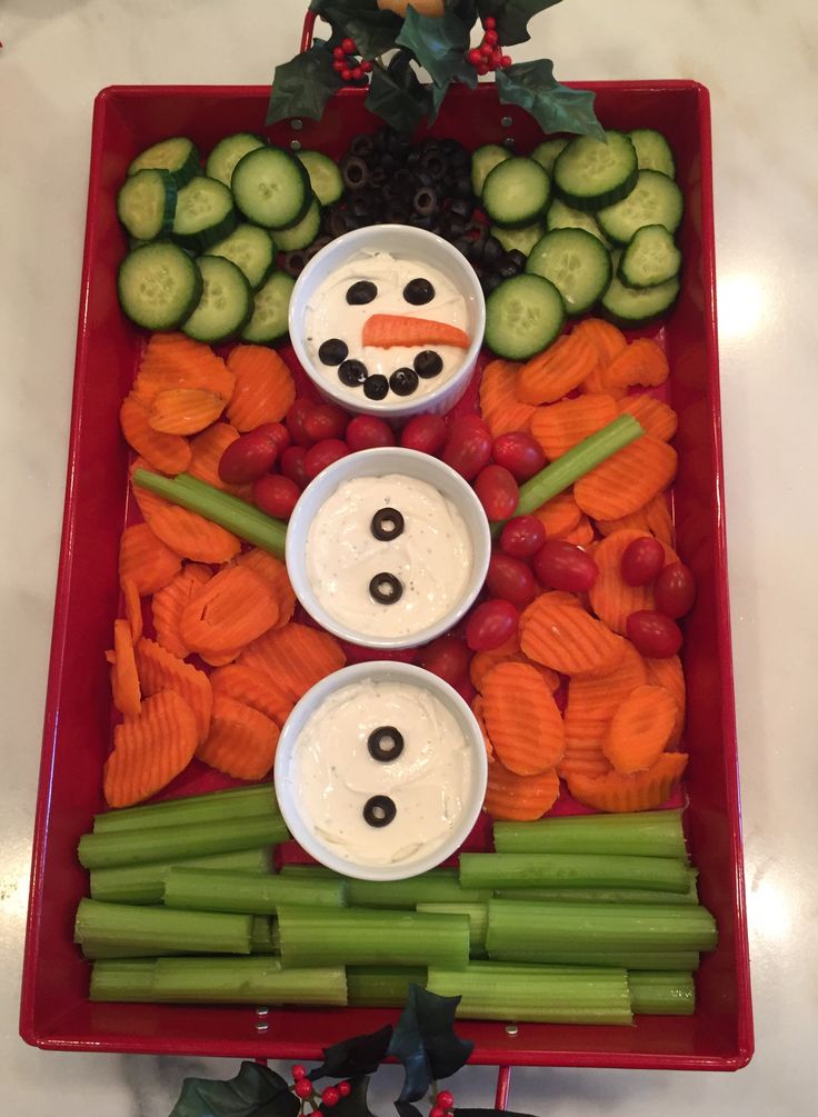 a tray with carrots, cucumbers, celery and other vegetables