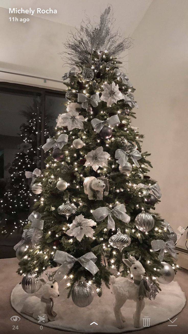 a christmas tree decorated with silver and white ornaments