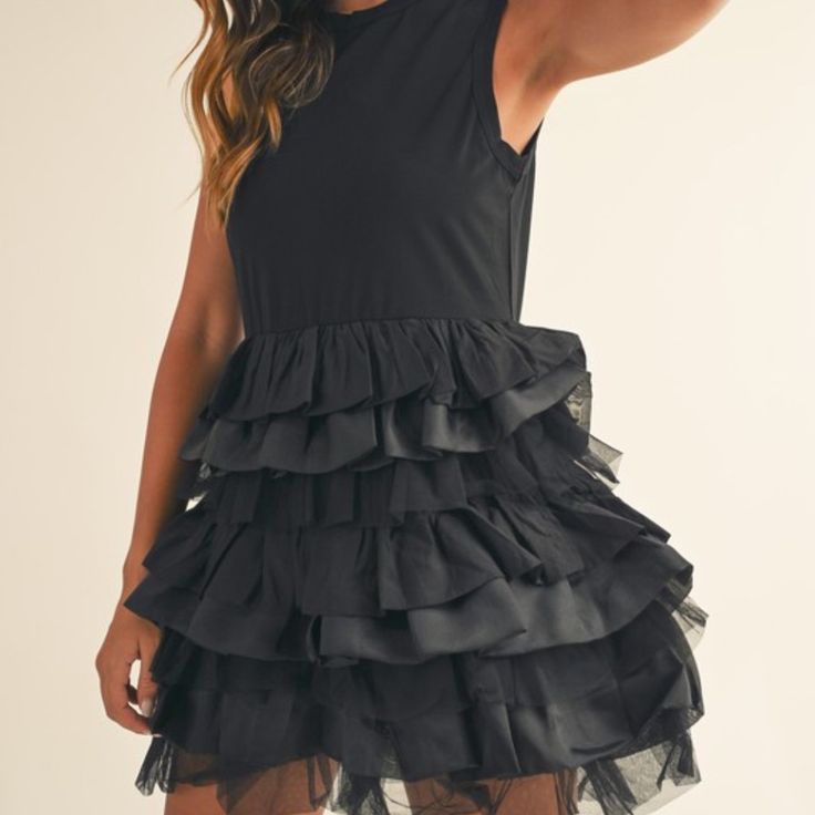 Description: The Millie Tiered Ruffle Mini Dress Features A Sleeveless Design And Delicate Ruffles, Adding A Touch Of Elegance To Your Wardrobe. Made With A Mix Of Fabrics, This Dress Offers Comfort And Style For Any Occasion. Fit: True To Size Content: 66% Rayon 26% Nylon 8% Spandex Elegant Sleeveless Mini Dress With Layered Hem, Black Ruffle Hem Dress For Summer, Elegant Sleeveless Layered Mini Dress, Black Sleeveless Mini Dress With Ruffles, Black Mini Sleeveless Dress With Ruffles, Chic Sleeveless Dress With Layered Hem, Elegant Layered Sleeveless Mini Dress, Layered Fitted Sleeveless Dress, Sleeveless Ruffle Dress With Layered Hem For Party