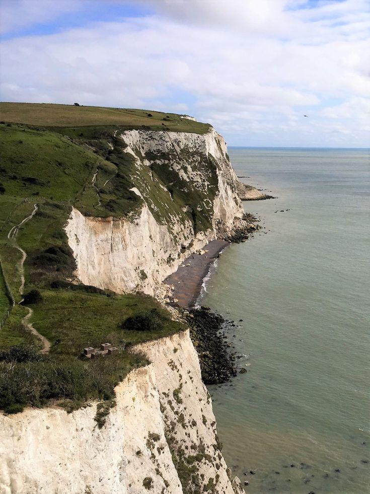 the cliffs are white with green grass on them