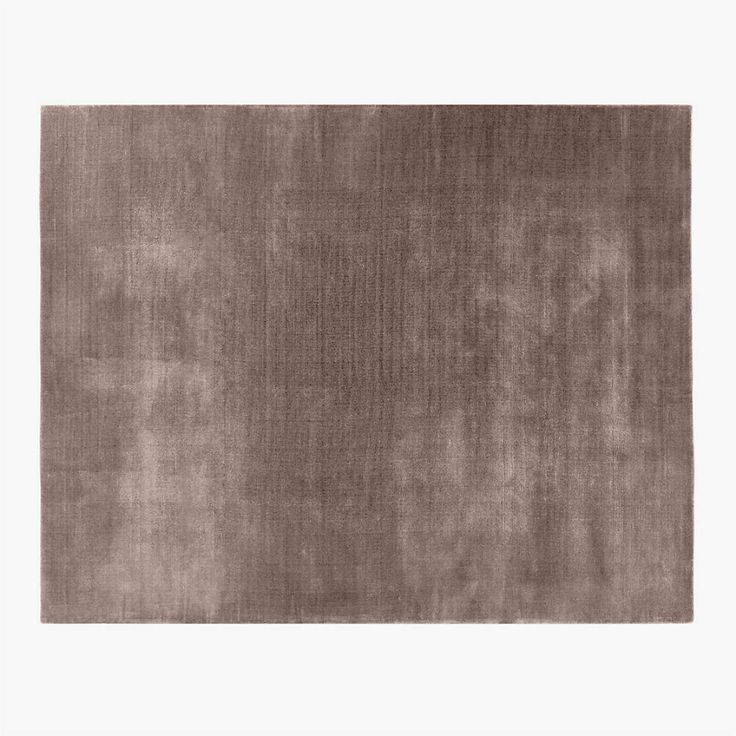 a brown rug on top of a white floor