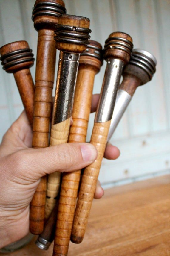 a person is holding several wooden objects in their hand