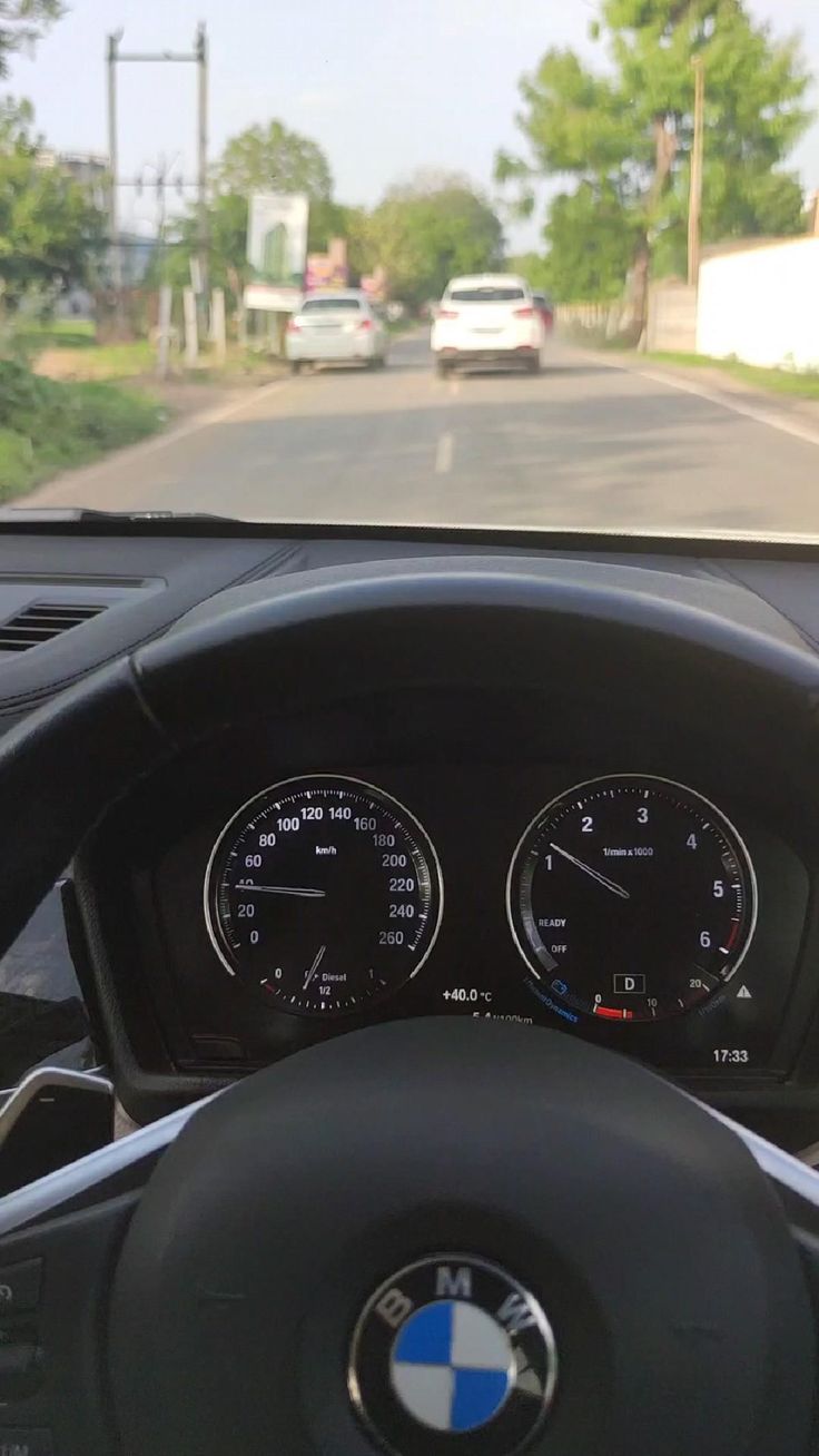 the dashboard of a bmw car on a road