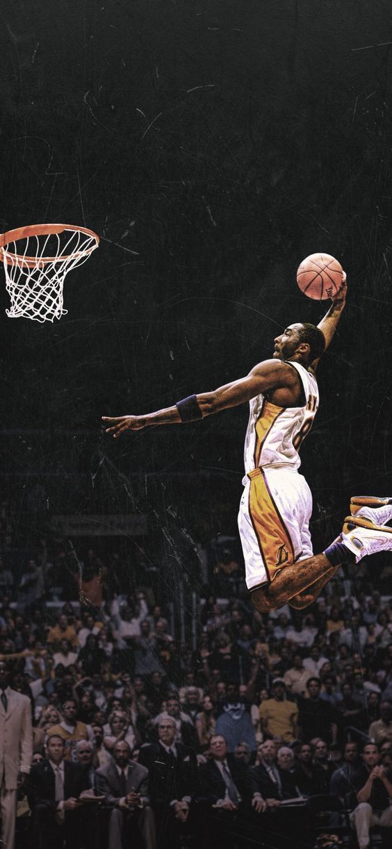 a basketball player jumping up into the air to dunk a ball in front of an audience