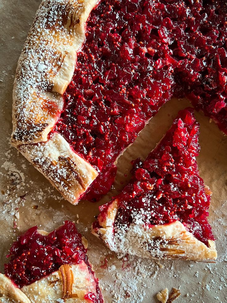 a piece of pie with powdered sugar on top and one slice missing from it