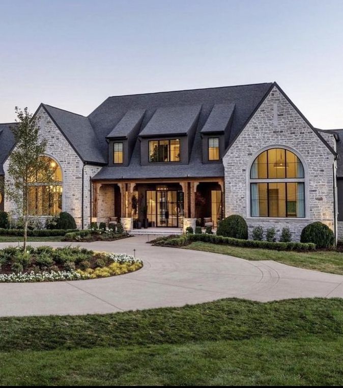 a large house with lots of windows and landscaping