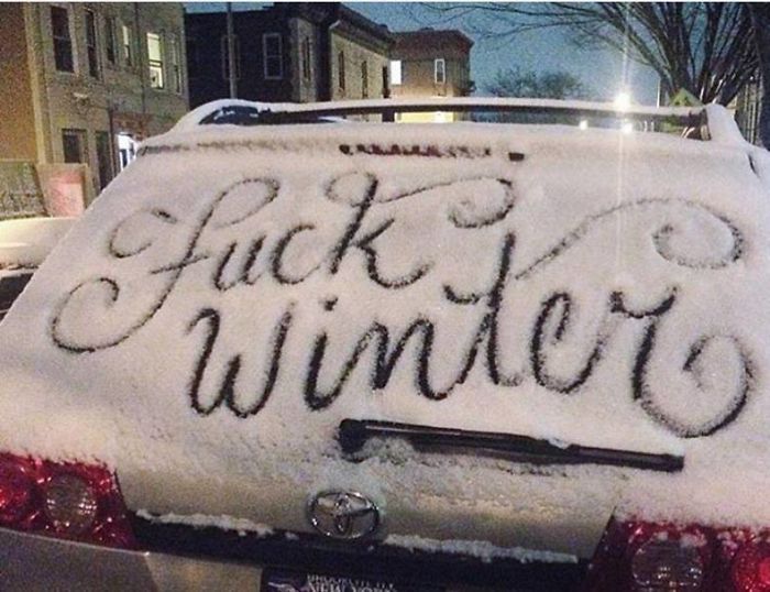 a car covered in snow with writing on it