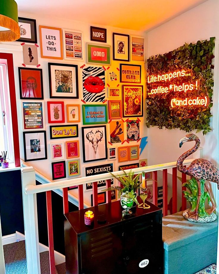 a living room filled with lots of framed pictures on the wall and a dresser in front of it