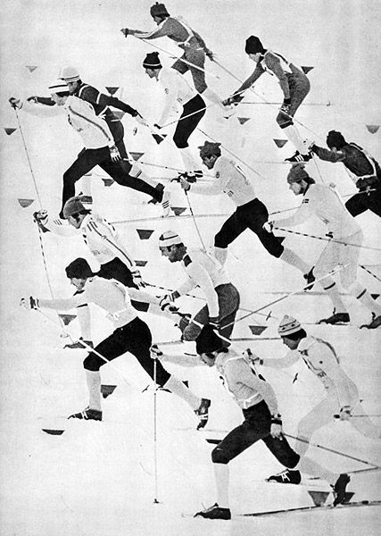 an old black and white photo of men skiing