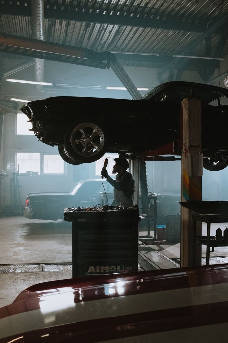 a man working on a car in a garage